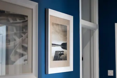 a picture on a blue wall in a room at 2 Bedroom in the Heart of Loch Lomond in Balloch