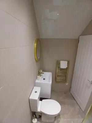 a bathroom with a white toilet and a sink at Castle View 3 bedroom with garden in Dumbarton