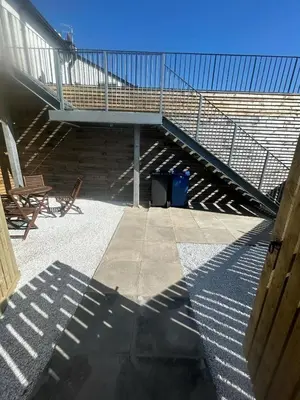 a stairway with a stair case and a chair at Castle View 3 bedroom with garden in Dumbarton
