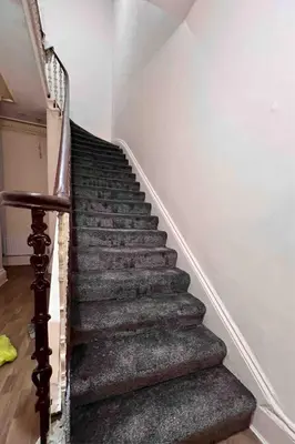 a staircase in a house with a stair case at Cheerful 5 Bedroom House Close to Central West End and Parking in Glasgow