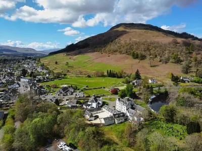 an aerial view of a town with a mountain at Luxury 2 Bed cottage in Killin in Killin