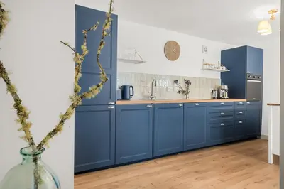 a kitchen with blue cabinets and a vase at Luxury 2 Bed cottage in Killin in Killin