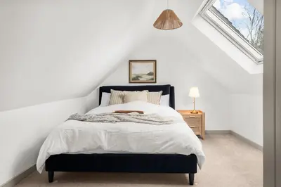 a bedroom with a king sized bed in a attic at Luxury 2 Bed cottage in Killin in Killin