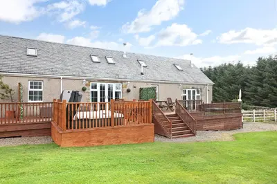 a large deck with wooden railings in front of a house at Greenknowes Entire Private Estate in Kelty