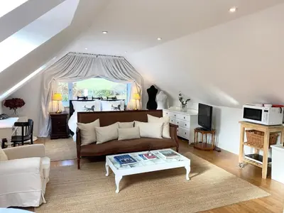 a living room with a couch and a table at Converted Historical Stone Coach House in Glasgow