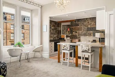 a kitchen with a table and chairs in a room at Stunning 1Bedroom Central Apartment in Oban