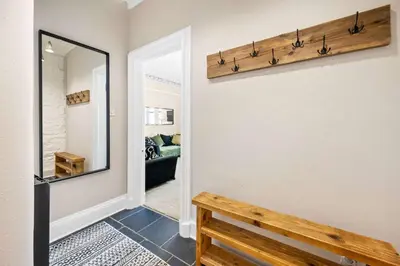 a hallway with a mirror and a bench at Stunning 1Bedroom Central Apartment in Oban