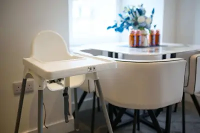 a white table and some white chairs in a room at Modern & Bright 2BR Flat - Short Walk to Town in Oban