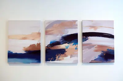 a group of four paintings on a white wall at Modern & Bright 2BR Flat - Short Walk to Town in Oban