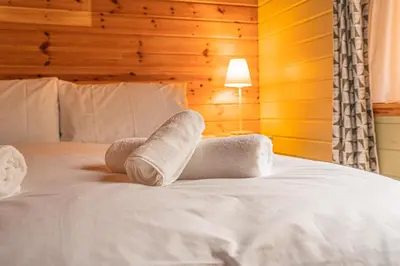 a pair of towels sitting on top of a bed at Lodge 4 in Stirling
