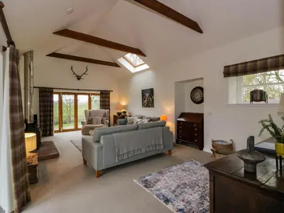 a living room with a couch and a table at The Stables in Thornhill