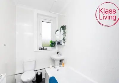 a white bathroom with a toilet and a sink at Sanderson Upper by Klass Living Uddingston in Uddingston