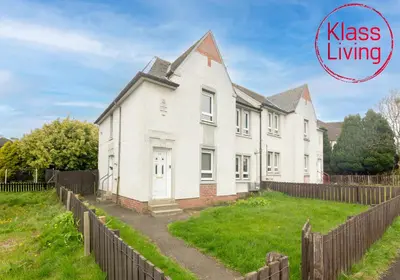 a white house with a fence in front of it at Sanderson Upper by Klass Living Uddingston in Uddingston