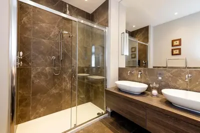 a bathroom with two sinks and a shower at Melville Street Townhouse in Edinburgh