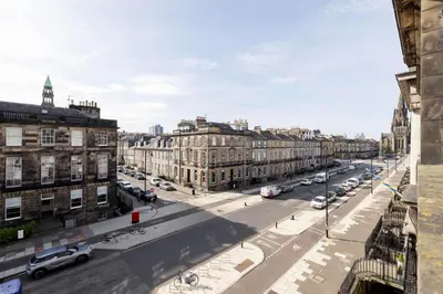 a view of a city street with cars and buildings at Melville Street Townhouse in Edinburgh