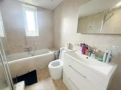 a bathroom with a toilet and a sink and a bath tub at Galaxy Glasgow 67 in Cardonald