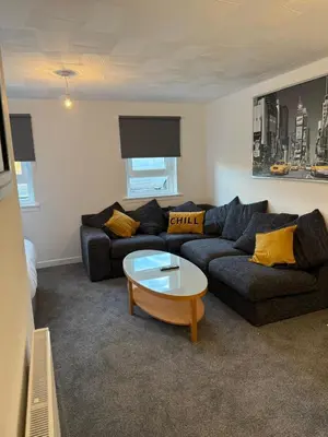 a living room with a couch and a coffee table at 2-Bed City Apartment by Glasgow Green in Glasgow