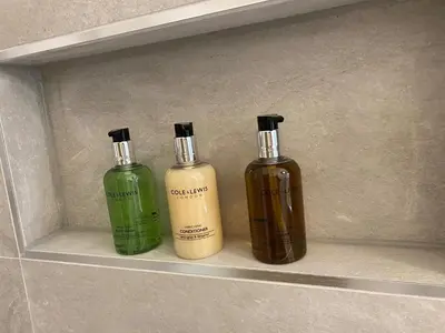 two bottles of soap sitting on a shelf at Spacious 2 bed sleeps 5 above traditional music pub in Paisley
