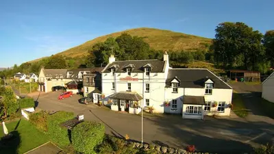 an aerial view of a house with a hill in the background at Cairndow Stagecoach Inn in Cairndow
