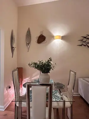 a dining room with a glass table with a vase on it at Marina 2bedroom Beach Nearby Swansea City in Moffat