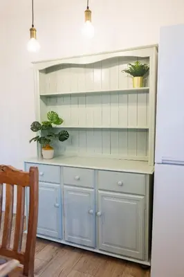 a kitchen with blue cabinets and a white refrigerator at Birchgate Bothy - Spacious 4 Bedroom Home in Dunoon in Dunoon