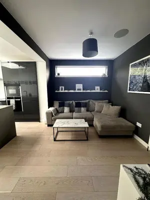 a living room with a couch and a table at Kaimes Kip Stylish Edinburgh Five Bedroom Home in Edinburgh