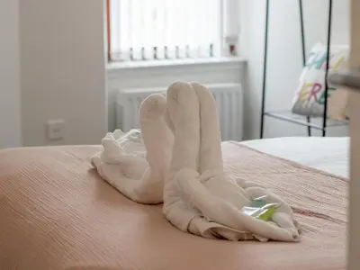 a pair of towels on top of a bed at Pass the Keys Stay in Glasgow South in Glasgow