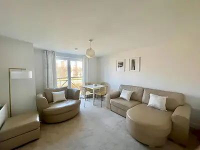 a living room with a couch and chairs and a table at Pass the Keys Next to Braehead - Free Parking in Renfrew