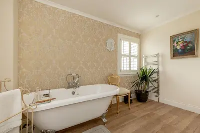 a bathroom with a white bath tub in a room at Persie Croft Bed & Breakfast in Auchterarder