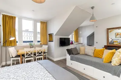 a living room with a couch and a table at Haymarket Apartments in Edinburgh