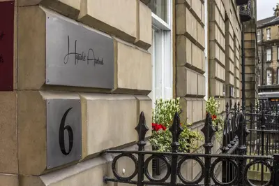 a building with a sign on the side of it at Haymarket Apartments in Edinburgh