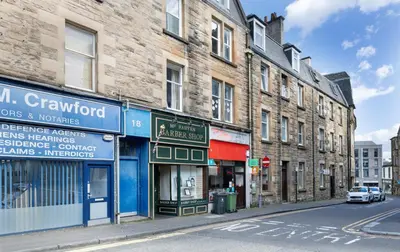 a street with buildings on a city street at Ochill View Apartment by Stirling Train Station in Stirling