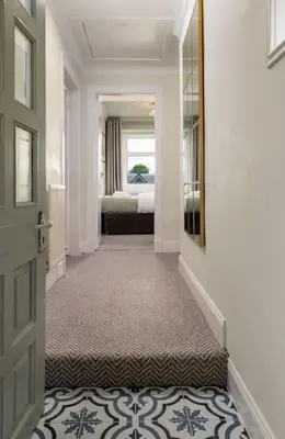 a hallway with a door leading to a bedroom at Central Cathedral Apartment in Dunblane