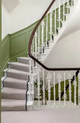 a staircase with white railings and green walls at Historic Trackside Retreat, Charming Getaway in Stirling
