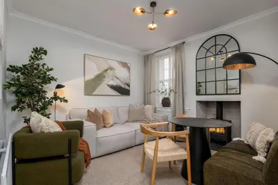 a living room with a couch and a table at Woodland Hideaway Near Stirling in Cambusbarron