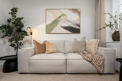 a living room with a couch with pillows on it at Woodland Hideaway Near Stirling in Cambusbarron