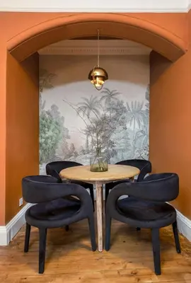 a dining room with a table and four chairs at Stylish Penthouse Retreat in Stirling