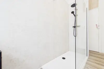 a bathroom with a shower with a glass door at West End Traditional Flat with Free Parking in Scotstoun West Station