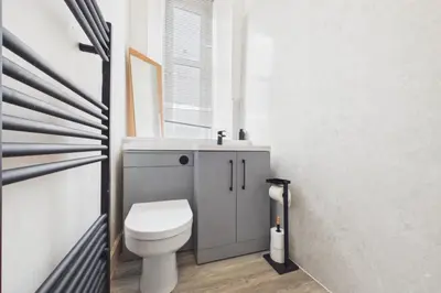 a bathroom with a toilet and a sink at West End Traditional Flat with Free Parking in Scotstoun West Station