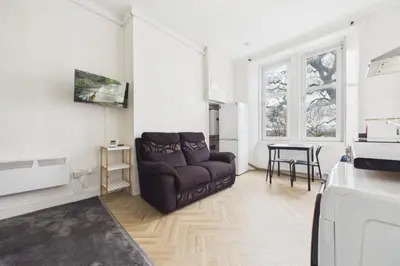 a living room with a couch and a table at West End Traditional Flat with Free Parking in Scotstoun West Station