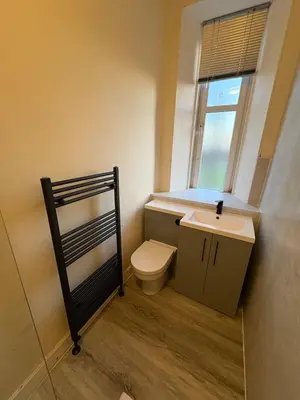 a bathroom with a toilet and a sink and a window at West End Traditional Flat with Free Parking in Scotstoun West Station