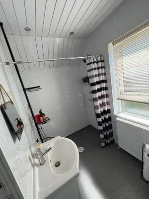 a bathroom with a sink and a shower at Chic & Cozy 2BR Semi-Detached in Kilmarnock