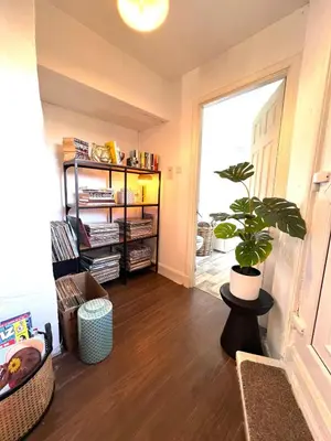 a living room with a potted plant and a window at Coatbridge central apartment 20 min from Glasgow in Coatbridge