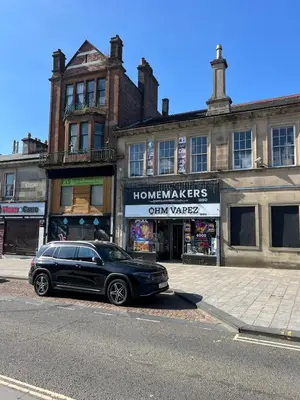 a black car parked on the side of a street at Coatbridge central apartment 20 min from Glasgow in Coatbridge