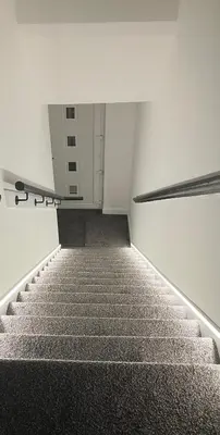 an empty stairway with a escalator in a building at CONTRACTOR STAYS WELCOME newly refurbished 2 bedroom apartment sleeps 5 with free SECURE parking and WiFi Fully Fitted Kitchen with Washer Dryer Weekly bedding change and hoover Long Term Stay Rate available 3 miles from City Centre in Cowlairs