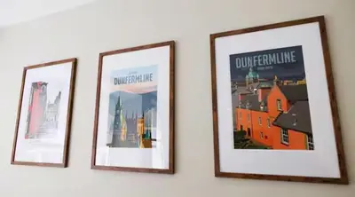 four framed pictures hanging on a wall at Stylish 3-Bed Apartment in the Heritage Quarter in Dunfermline