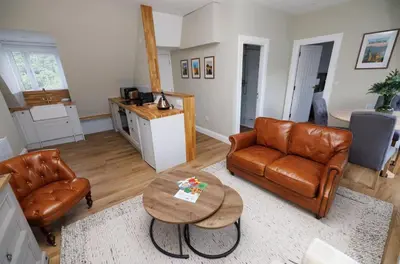 a living room with a couch and a table at Cosy Apartment in the Heritage Quarter - Sleeps 2 in Dunfermline
