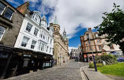a city street with buildings and a clock tower at Cosy Apartment in the Heritage Quarter - Sleeps 2 in Dunfermline