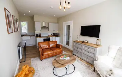 a living room with a couch and a table at Stylish 2-Bed Apartment in the Heritage Quarter in Dunfermline
