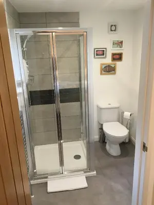 a bathroom with a shower and a toilet at The Anchor Inn in Garelochhead